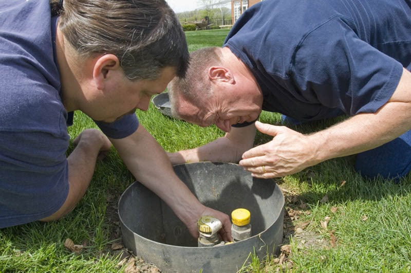 two men conducting sniff test to detect leak in propane system