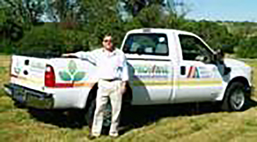 DLE President Bill Platz standing in front of propane-powered vehicle