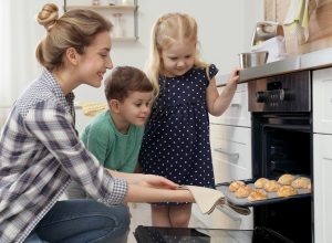 woman baking with childern