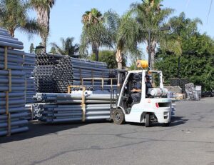 Propane forklift moving pipes