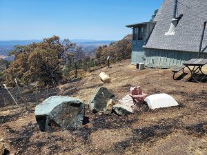 damage from Lake Fire in California extremely close to house with propane tank inbetween