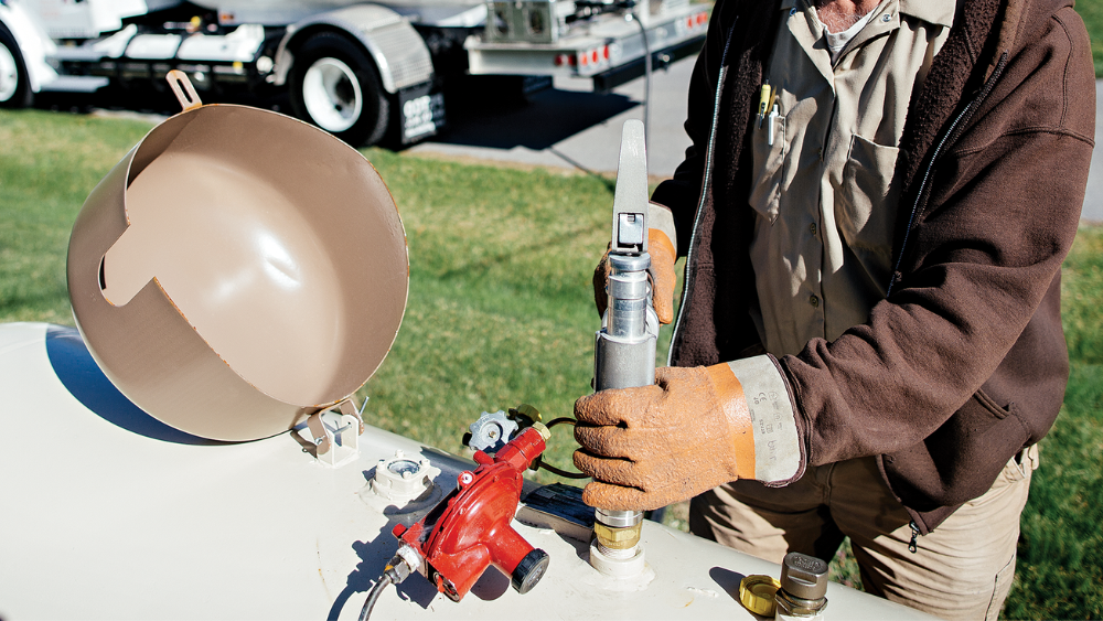 Propane technician servicing propane tank and doing propane safety checks