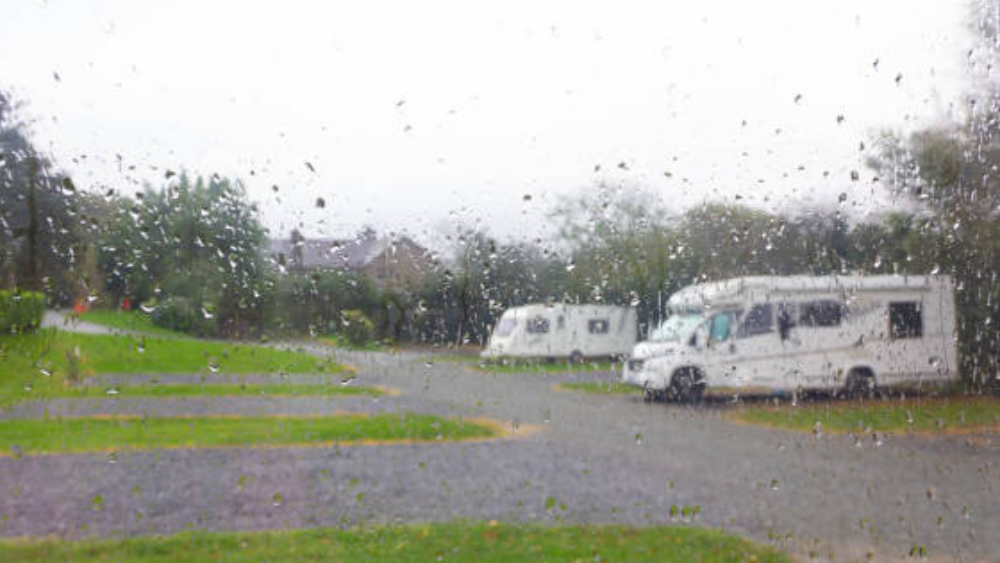RVs through a window with rain on it. El Niño RV Preparation: Protect Your RV From Heavy Rain - Delta RV blog Paso Robles RV servicing and accessoriesEl Niño RV Preparation: Protect Your RV From Heavy Rain - Delta RV blog Paso Robles RV servicing and accessories